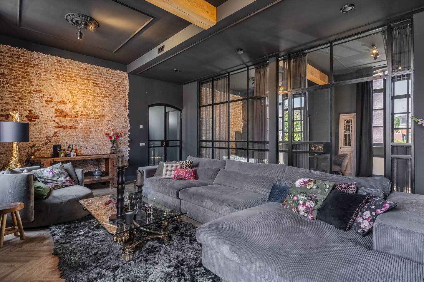 A Beautiful Loft Style Home in a Former Dutch Factory 7 gray living room raw brick feature wall