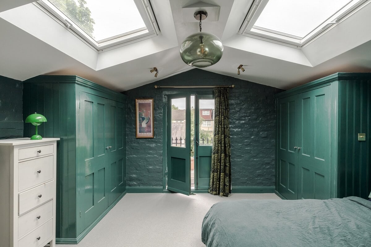 Exposed Materials and Green Tones in a London Stable Conversion 11 green bedroom pitched ceiling skylights