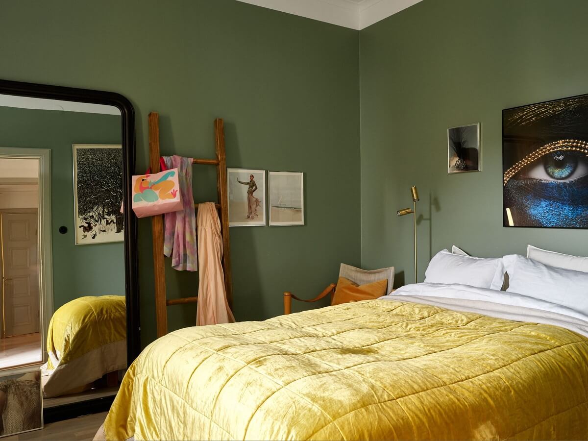 A Charming 1920s Apartment with a Green Bedroom 11 green bedroom with floor mirror and yellow bedding
