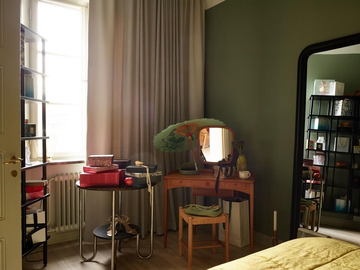 A Charming 1920s Apartment with a Green Bedroom 13 green bedroom with vintage vanity table