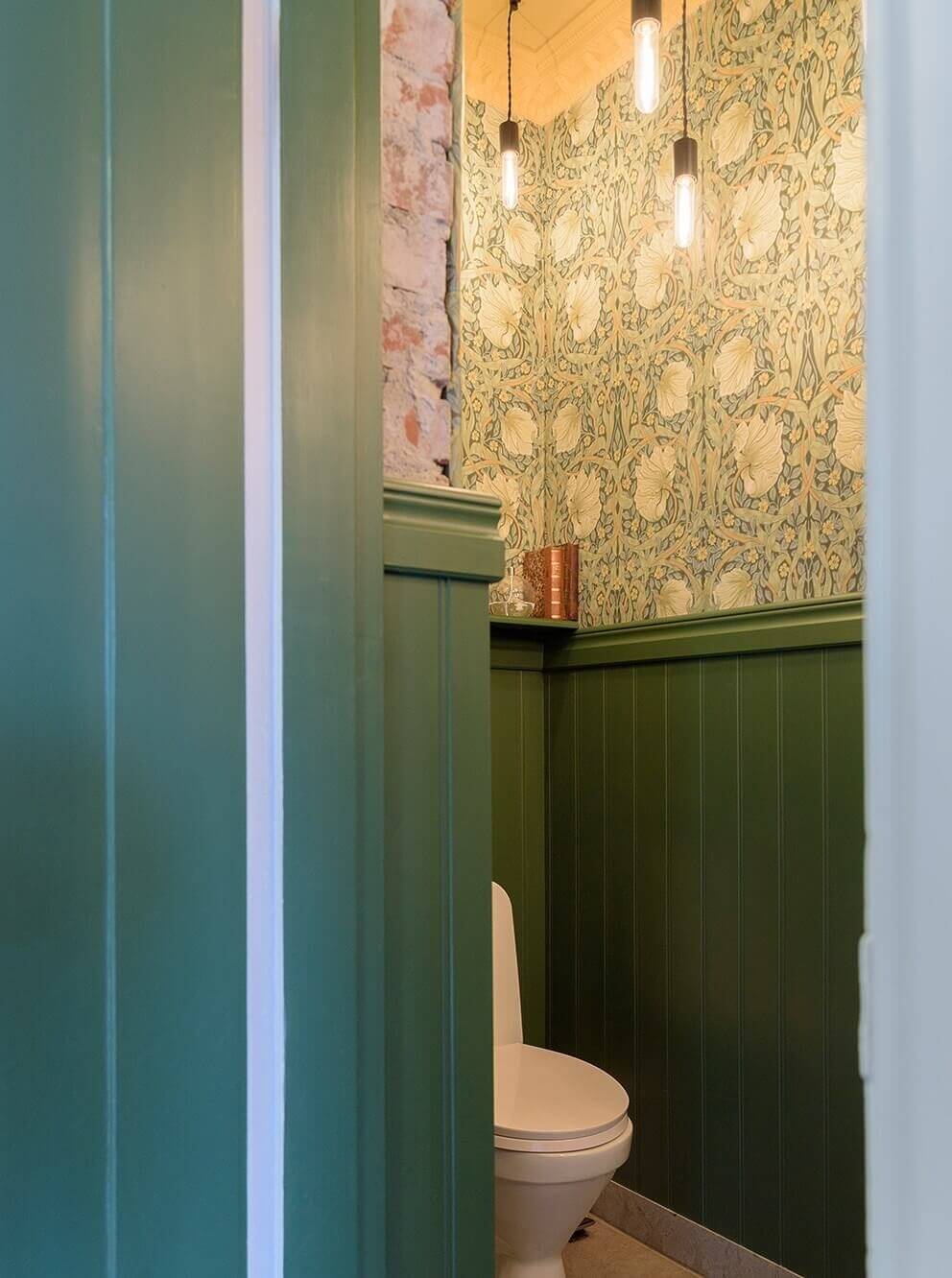 A Beautiful Family Home in a Grand 1930s Villa in Sweden 15 green powder room william morris wallpaper
