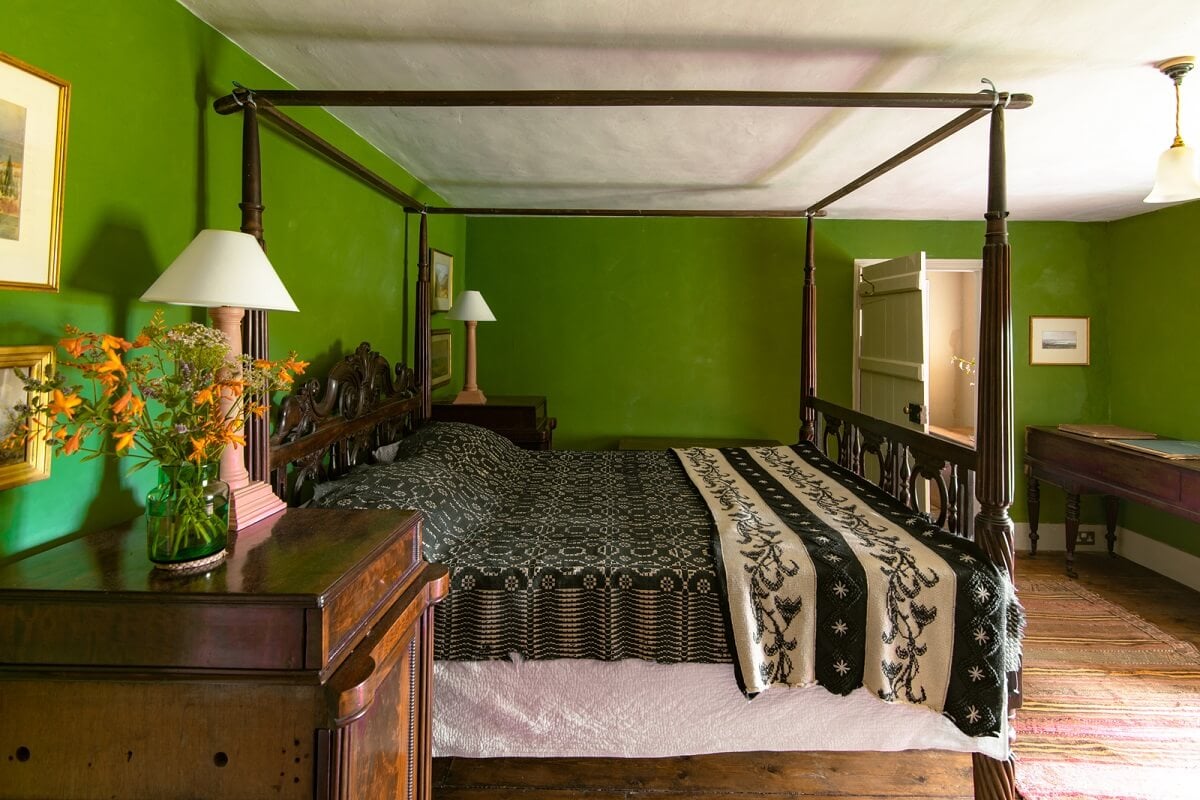 A Yellow Farmhouse with Bold Color Pops in Wales 19 green walls bedroom canopy bed
