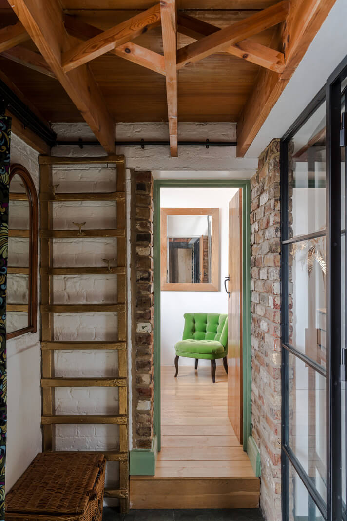 Exposed Materials and Green Tones in a London Stable Conversion 10 hall steel door wooden ceiling