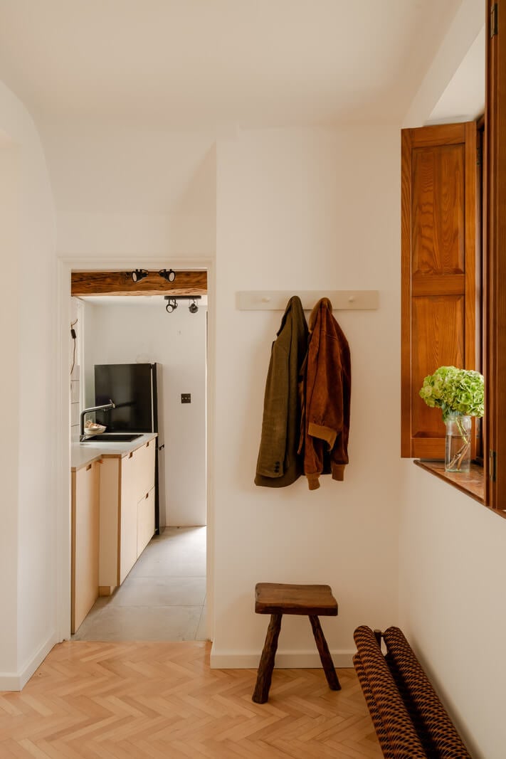 Pared Back Interiors and Light-Filled Spaces in a London Apartment 9 hall with window with wooden shutters