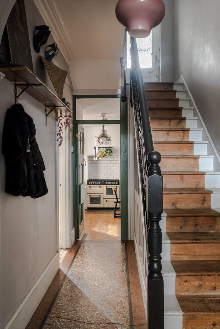 Pared-Back Interiors in a Late Victorian House 10 hall with wooden staircase