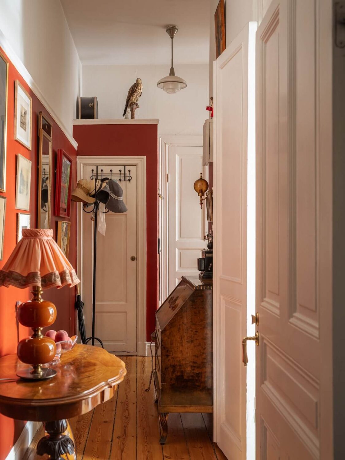 Antique Furniture and Arched Windows in a Stockholm Apartment 22 hallway with red accent wall Antique Furniture and Arched Windows in a Stockholm Apartment