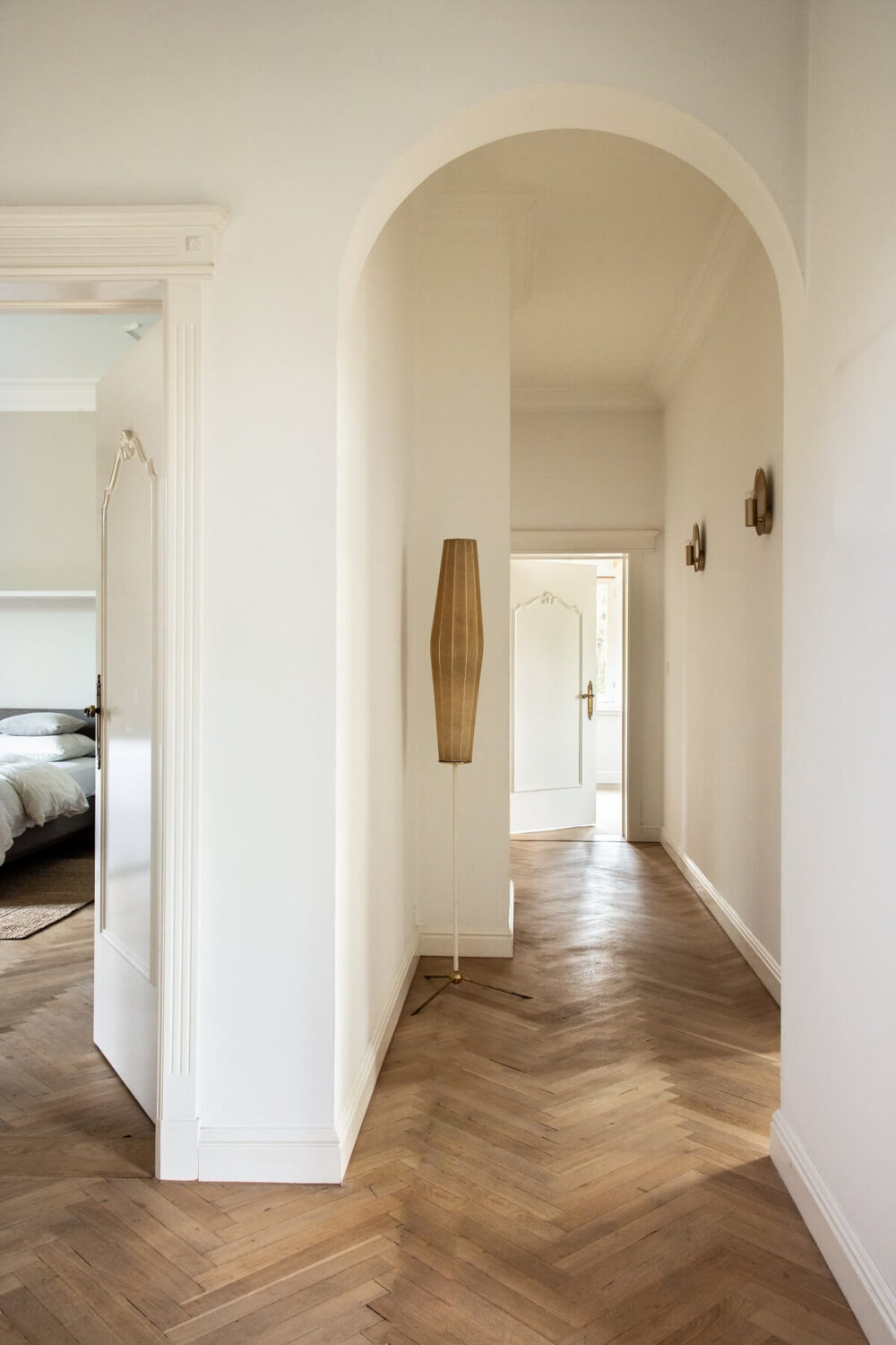 Historic Character and Timeless Elegant Interiors in a Restored Belgian Villa 20 hallway with wooden floor and arched doorway