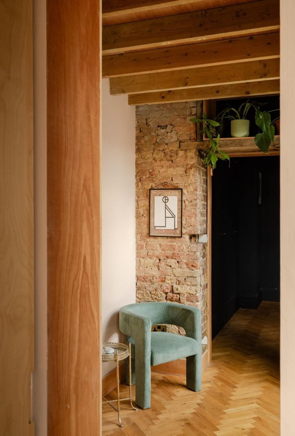 A Stunning Color Palette in an Extended Edwardian House in London 12 herringbone floor and brick feature wall nordroom