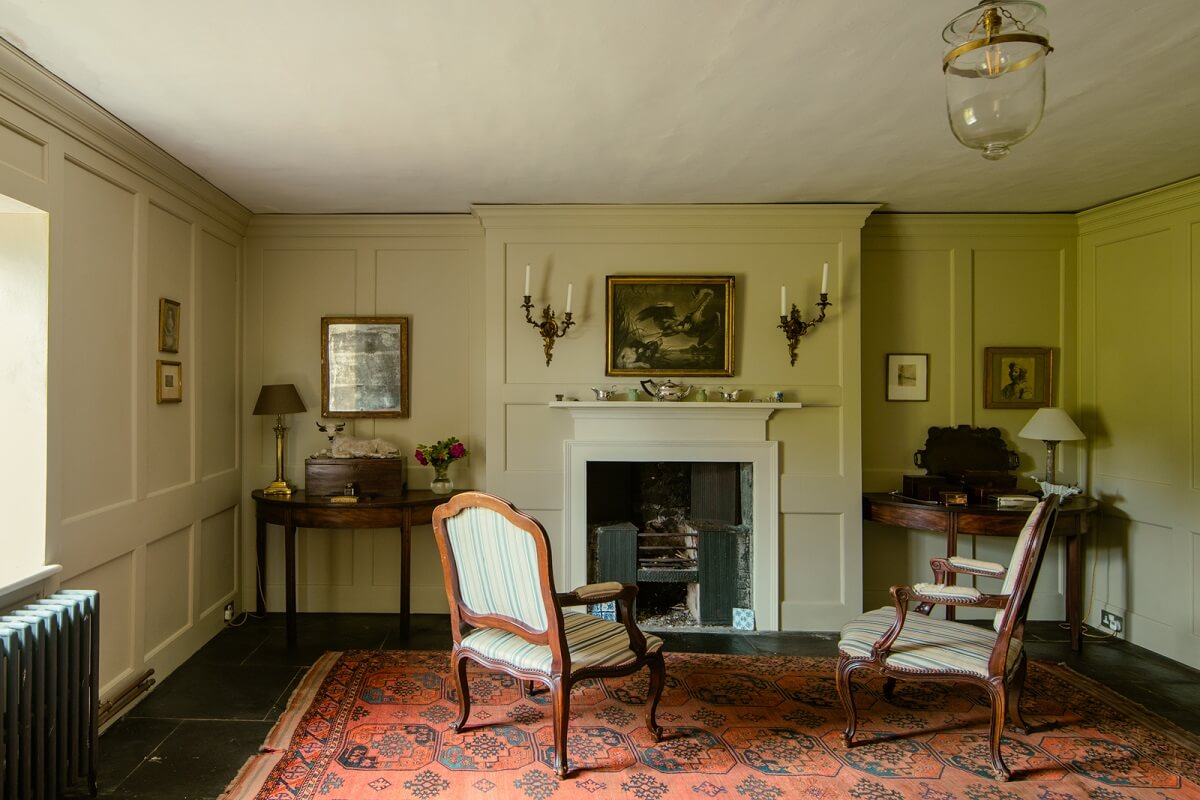 A Yellow Farmhouse with Bold Color Pops in Wales 5 historic farmhouse sitting room fireplace