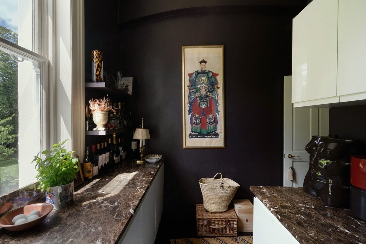 A Moody Color Palette and Eclectic Interiors in a London Apartment 8 kitchen black wall white cabinets marble worktops nordroom