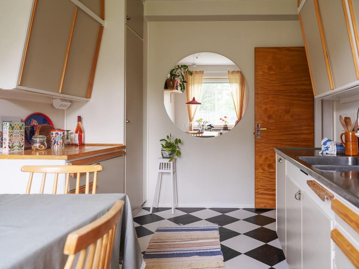 A Studio Apartment with Light Pink Walls and Vintage Furniture 18 kitchen checkerboard floor and midcentury cabinets A Studio Apartment with Light Pink Walls and Vintage Furniture
