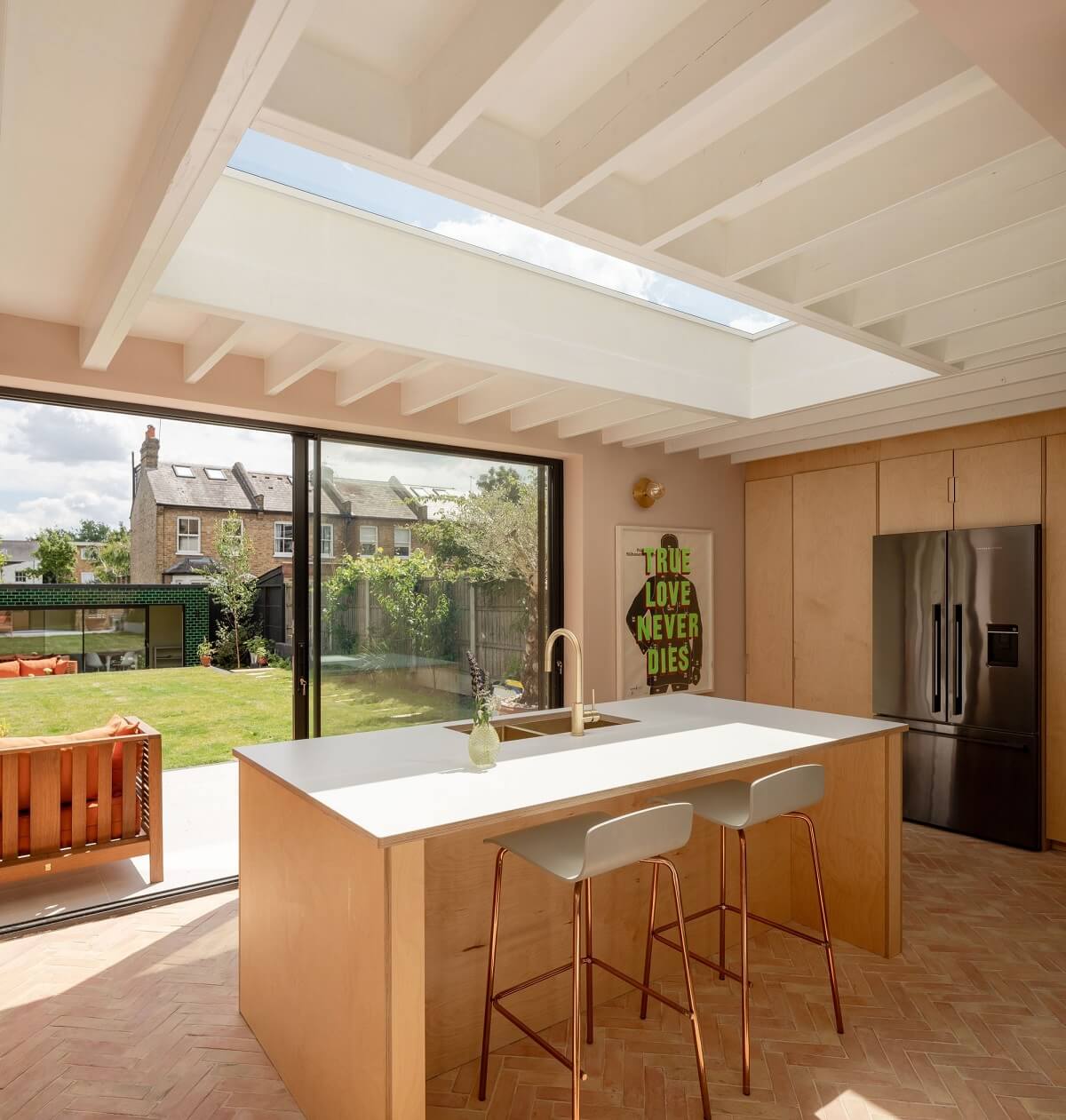 A Stunning Color Palette in an Extended Edwardian House in London 16 kitchen island with bar seating and skylight nordroom