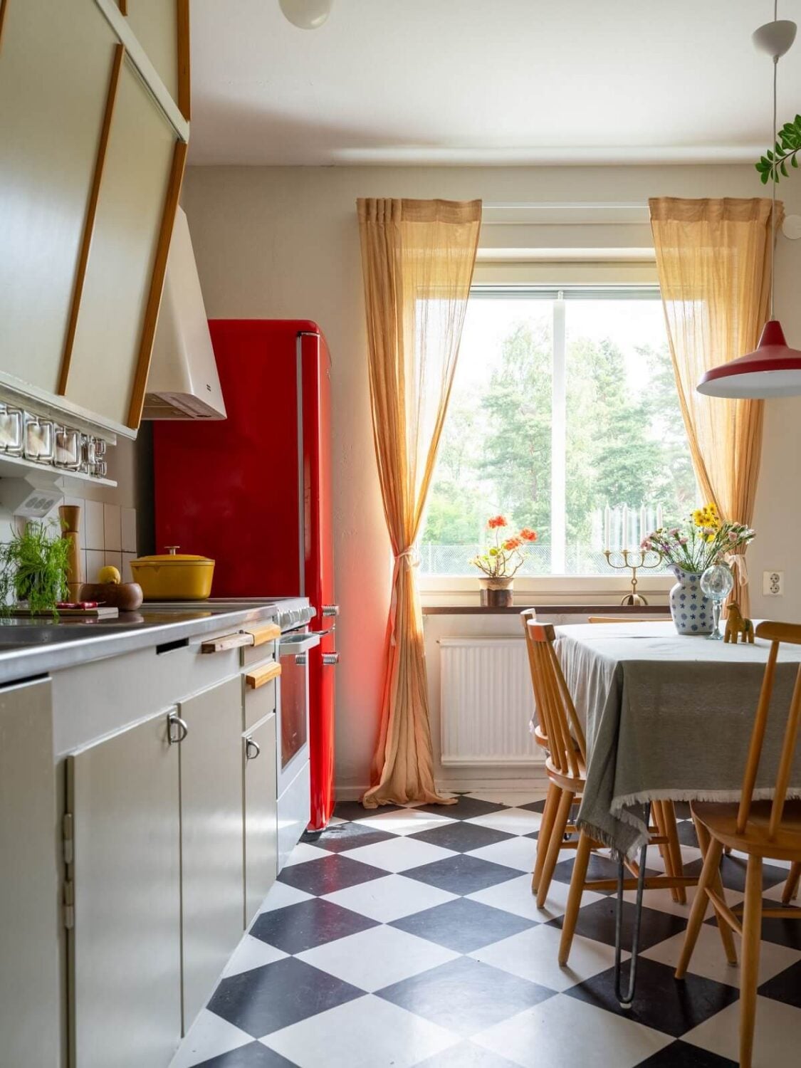 A Studio Apartment with Light Pink Walls and Vintage Furniture 14 kitchen midcentury cabinets red fridge checkerboard floor