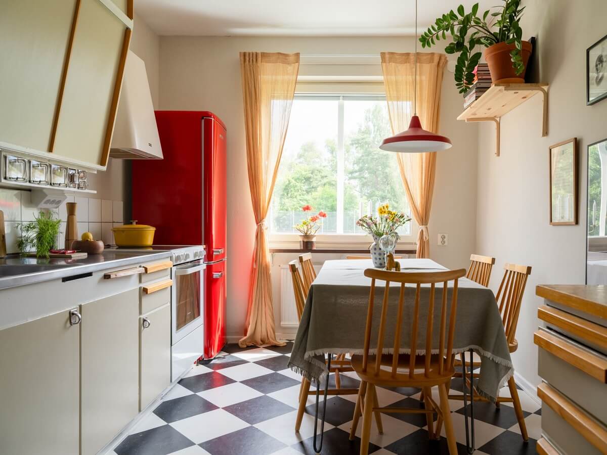 A Two-Bedroom Apartment with the Original Midcentury Kitchen 30 kitchen with dining table checkerboard floor red fridge