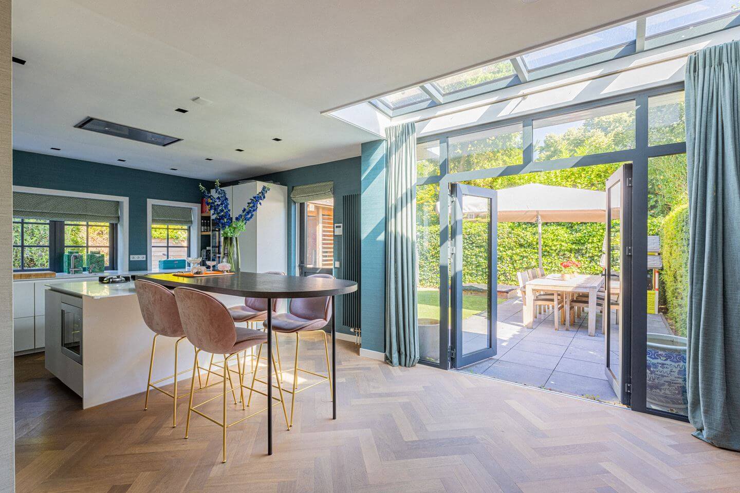 Bold Color Accents in a Dutch Family Home 7 kitchen with doors to garden