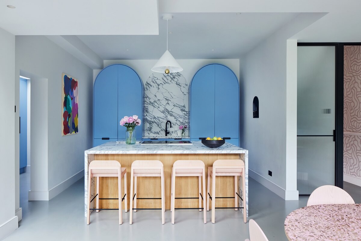 A London Family Home Decorated in Pastel Colors 9 kitchen with island and pastel blue cabinets nordroom
