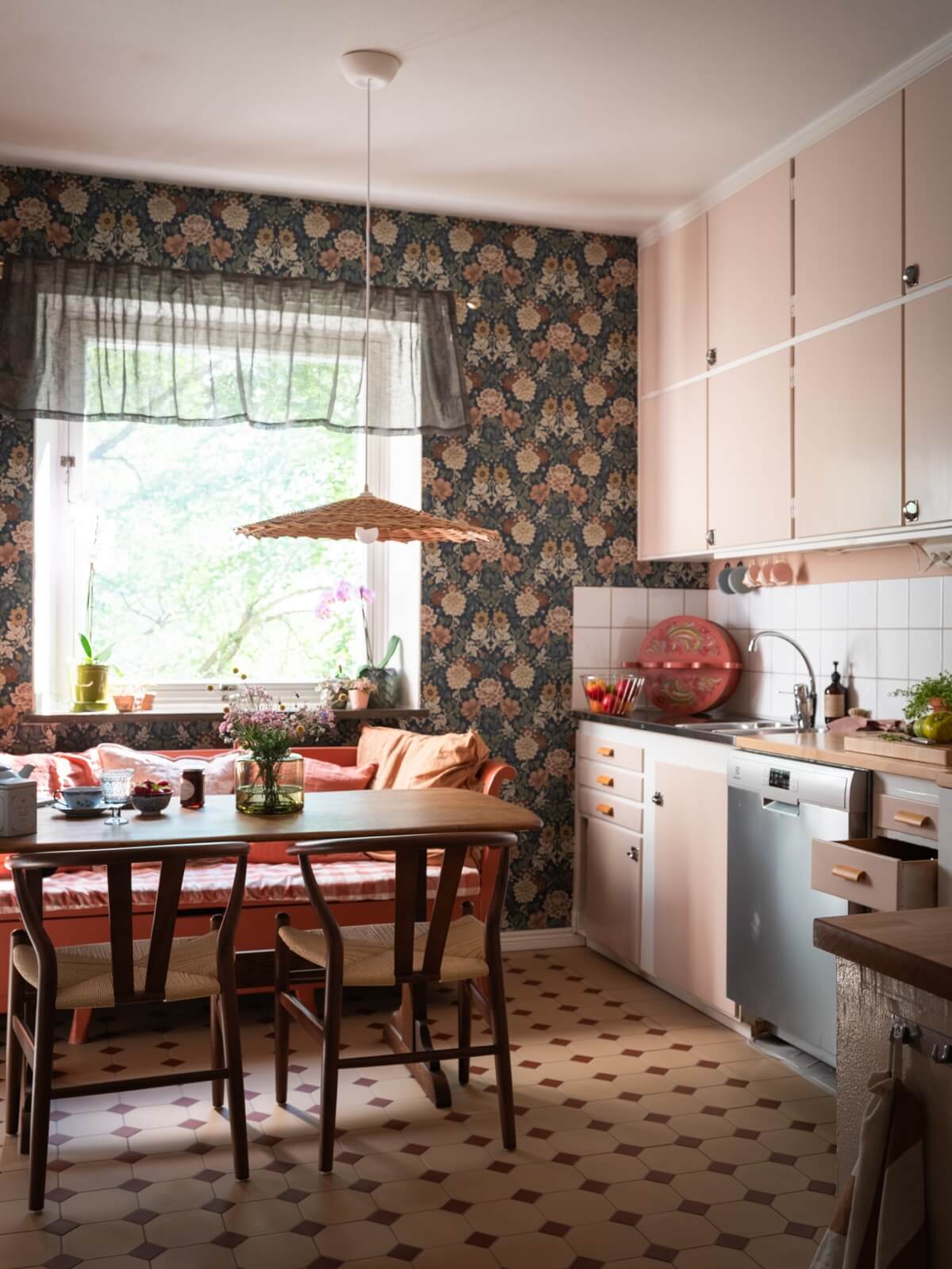 kitchen with pink cabinets floral wallpaper and breakfast table nordroom