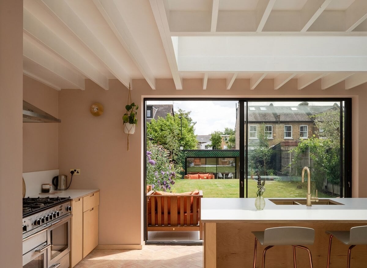 A Stunning Color Palette in an Extended Edwardian House in London 15 kitchen with white painted wooden ceiling and pink walls nordroom