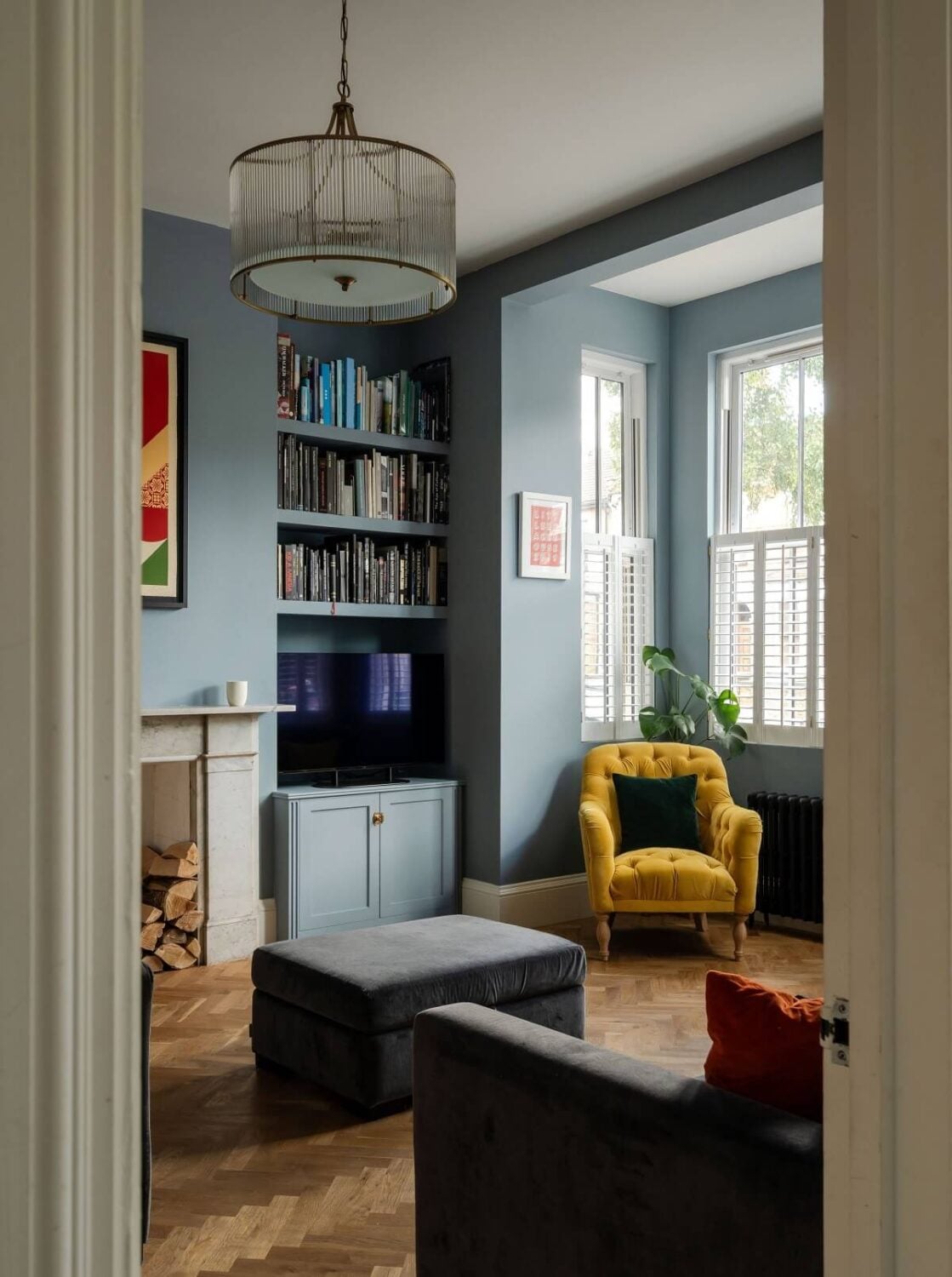 A Stunning Color Palette in an Extended Edwardian House in London 4 living room blue walls bookshelves nordroom