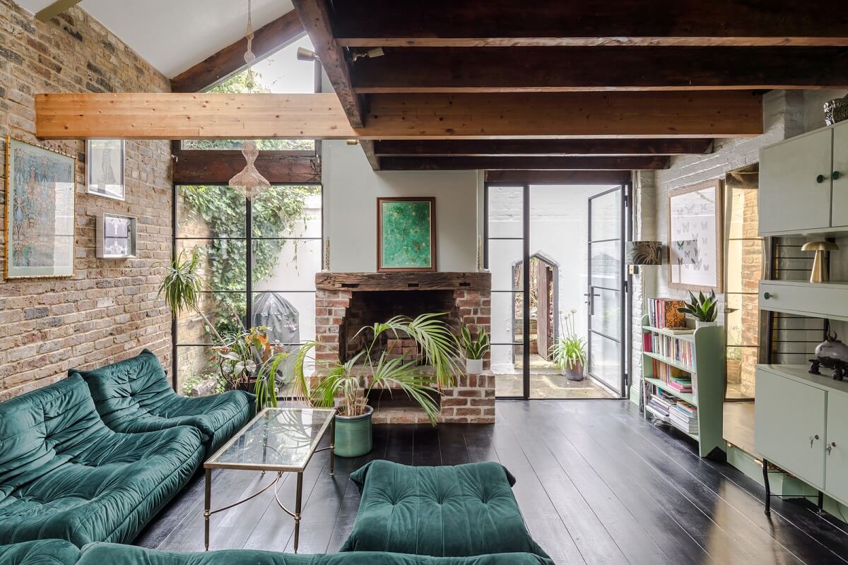 Exposed Materials and Green Tones in a London Stable Conversion 2 living room exposed beams brickwork green togo sofa nordroom