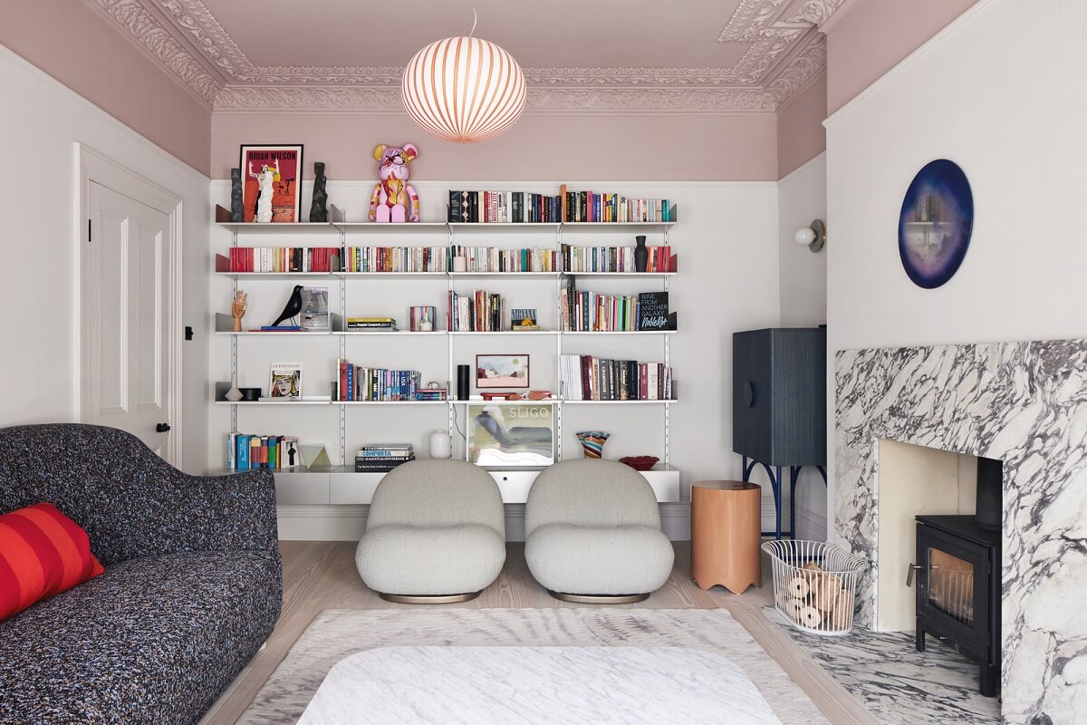 A London Family Home Decorated in Pastel Colors 1 living room pink ceiling bookshelves and marble fireplace nordroom