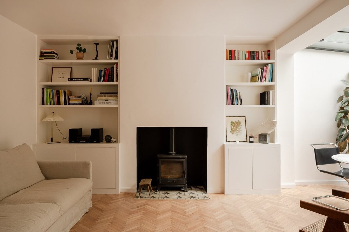 Pared Back Interiors and Light-Filled Spaces in a London Apartment 3 living room with built in shelves and wood burner