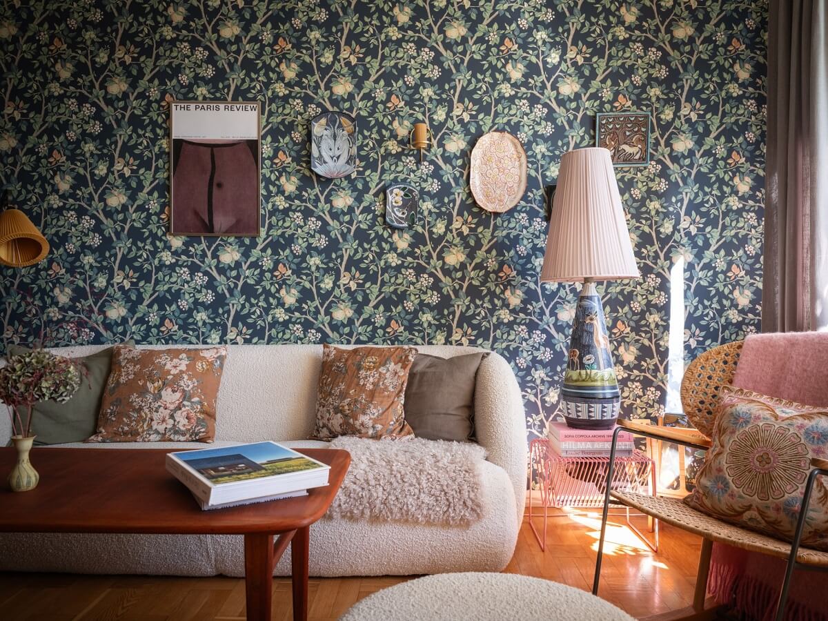 Floral Wallpaper and a Pink Kitchen in a Midcentury Apartment 2 living room with dark floral wallpaper and rocking chair