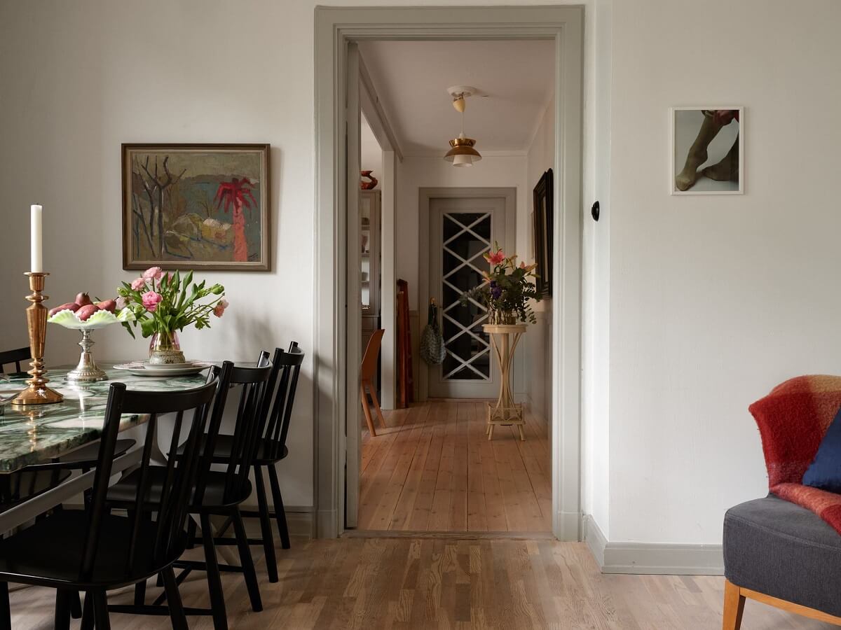 A Charming 1920s Apartment with a Green Bedroom 10 living room with dining table