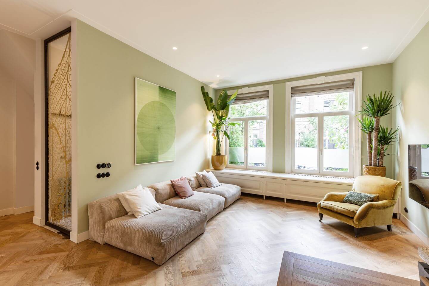 A Beautiful Renovated Duplex Apartment in Amsterdam 2 living room with pale green walls