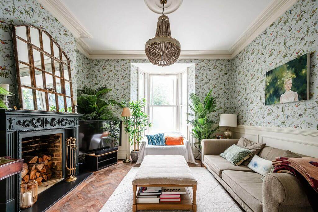 living room with wallpaper and fireplace An Open Plan Victorian House with a Lush Green Garden