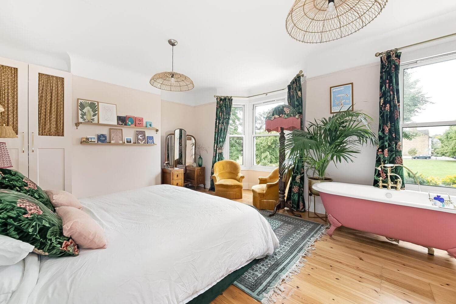 Playful Materials, Textures, and Colors in a London Home 14 master bedroom with pink bath and floral curtains