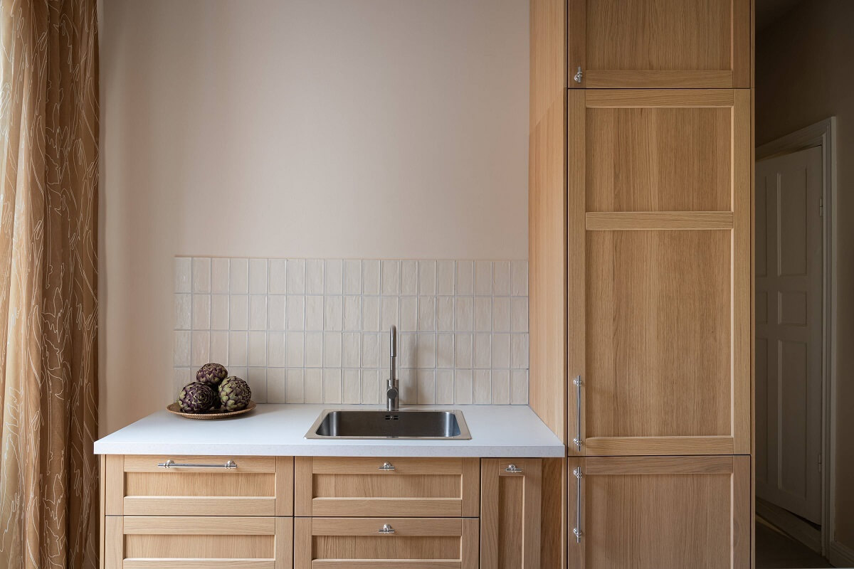 An Elegant Small Renovated Apartment in Stockholm 8 oak cabinets with beige italian tiles