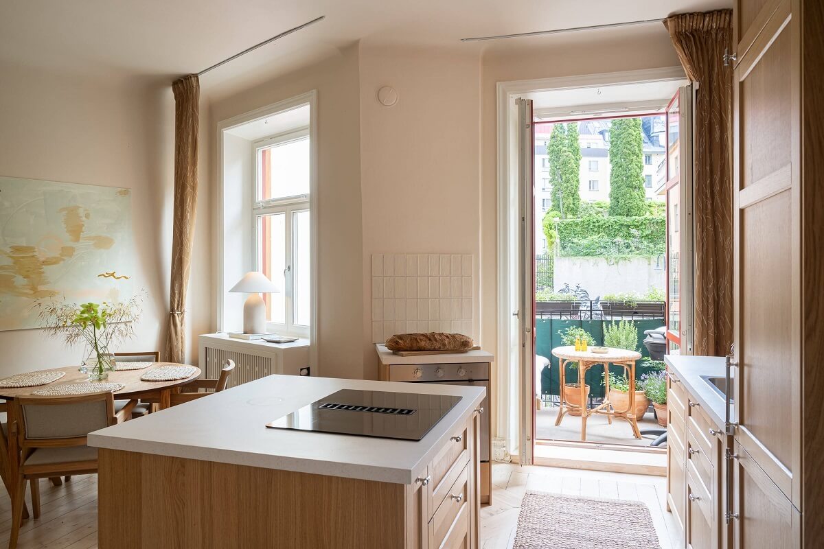 An Elegant Small Renovated Apartment in Stockholm 11 oak kitchen with balcony access