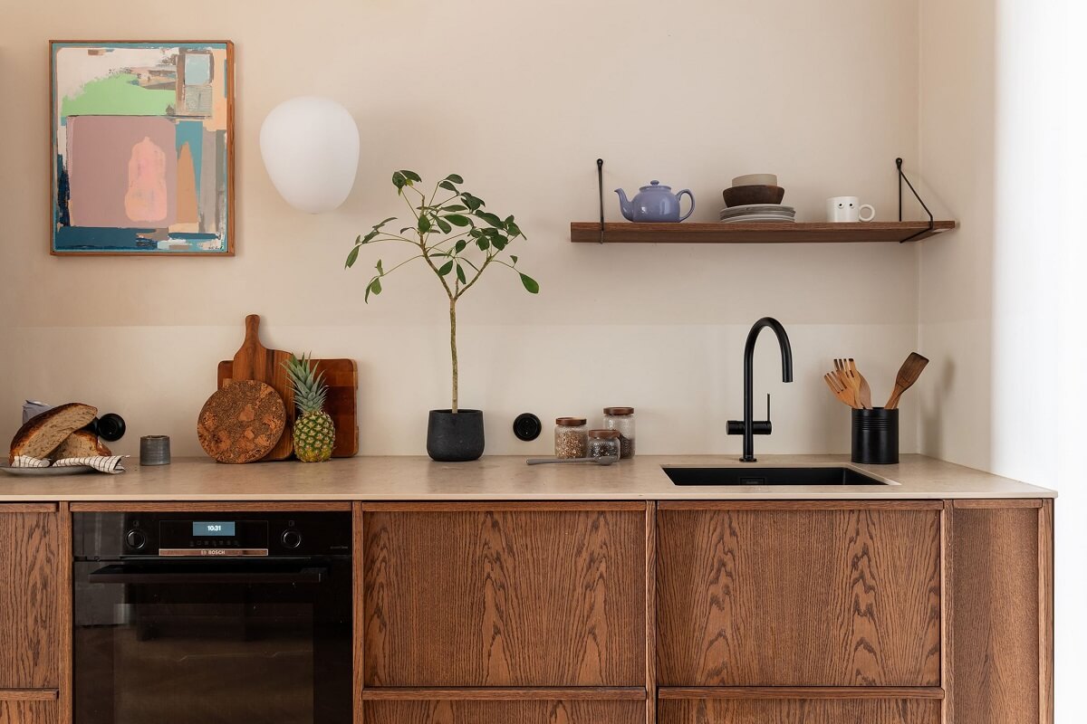 A Renovated Stockholm Apartment with Subtle Color Details 12 oak ktichen cabinets and black fittings