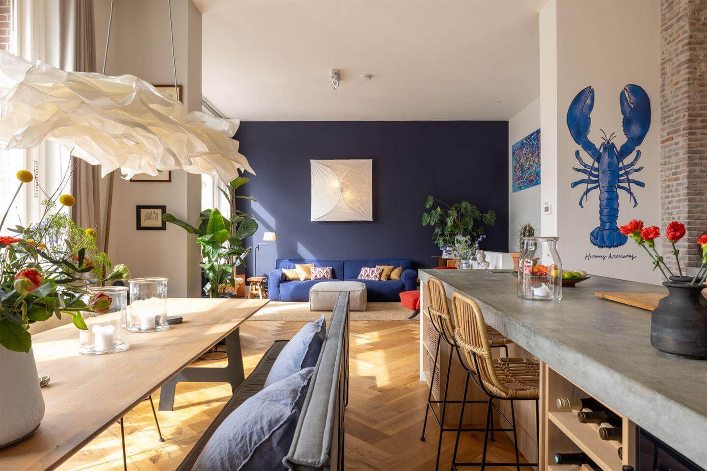 A Modern Duplex Apartment in The Netherlands 1 open plan kitchen living room blue feature wall