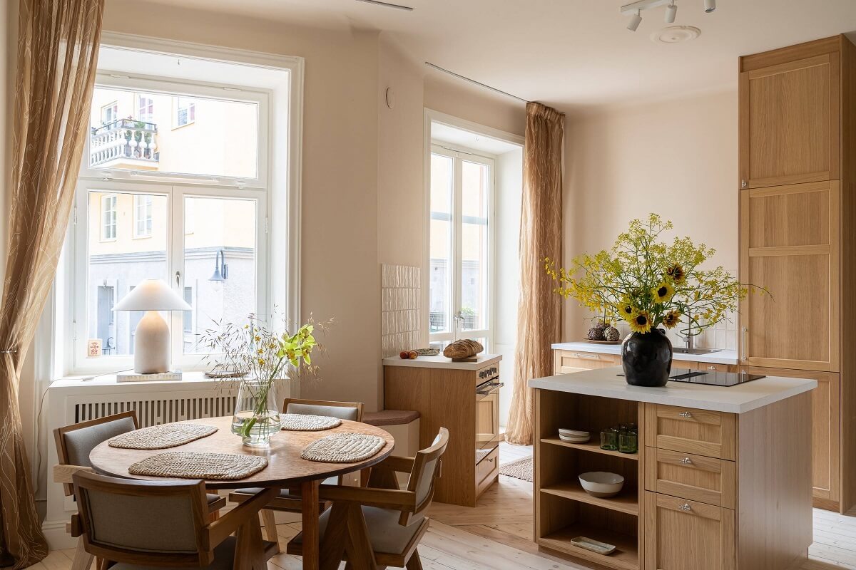 An Elegant Small Renovated Apartment in Stockholm 2 open plan living room kitchen with oak cabinets