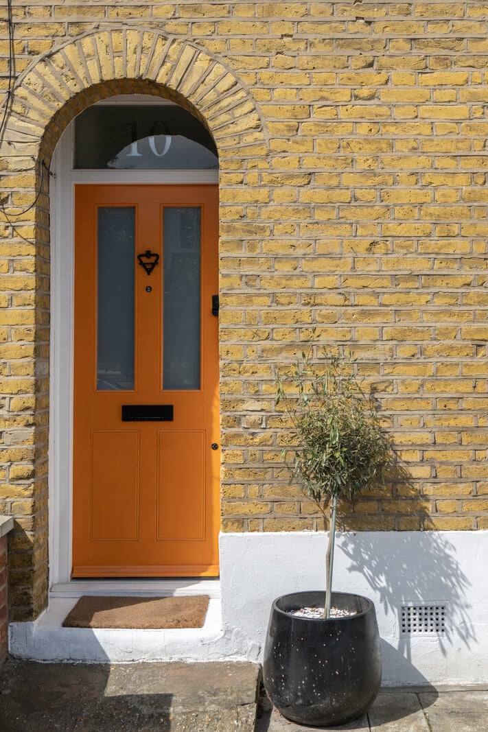 Blue Tones in a Two-Bedroom Victorian Cottage 19 orange front door Blue Tones in a Two-Bedroom Victorian Cottage