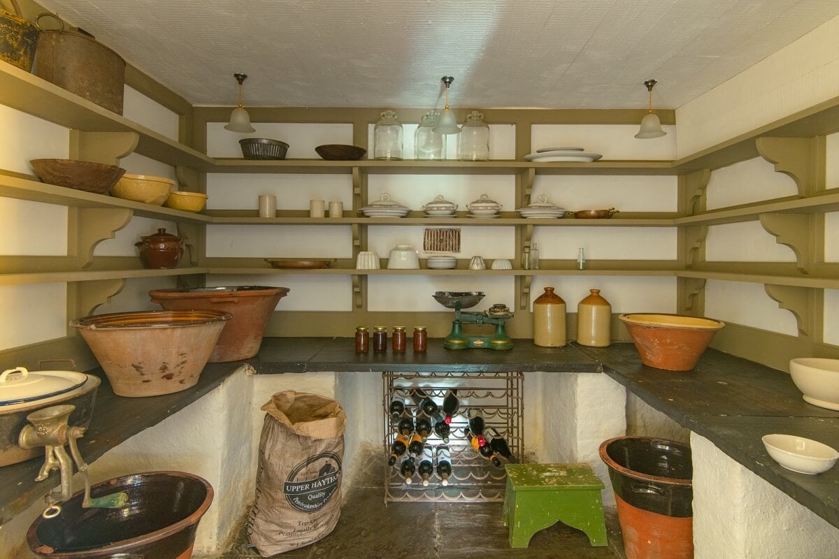 A Yellow Farmhouse with Bold Color Pops in Wales 10 pantry with shelves