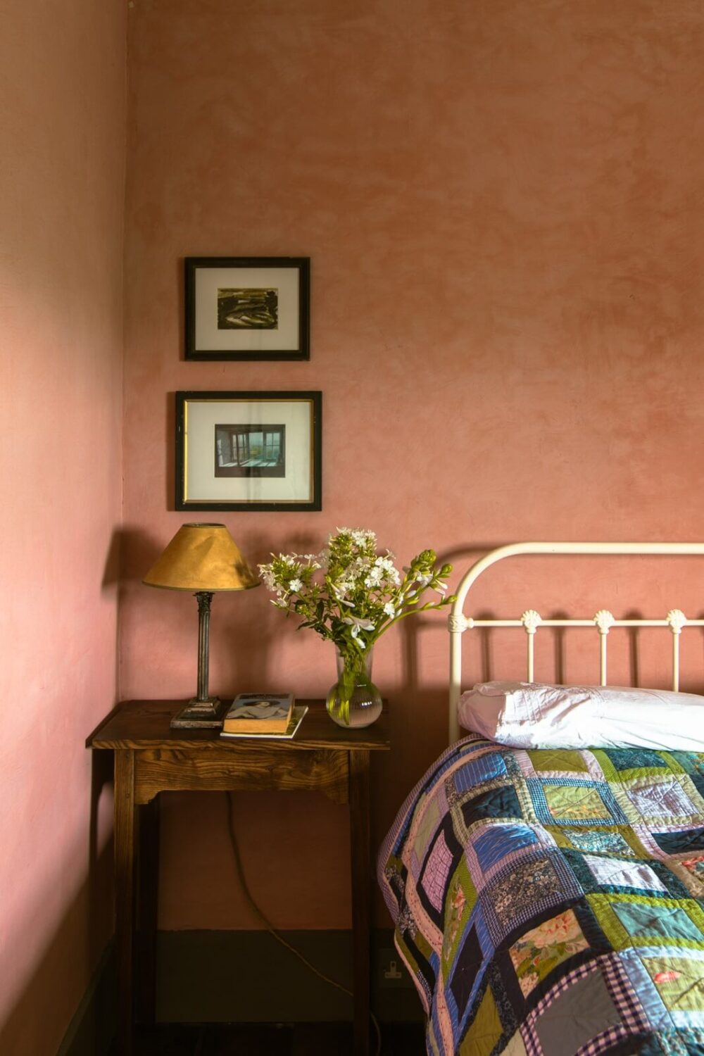 A Yellow Farmhouse with Bold Color Pops in Wales 16 pink plaster walls nightstand bedroom