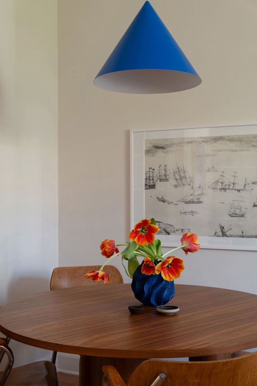 A Renovated Stockholm Apartment with Subtle Color Details 7 round dining table with blue pendant