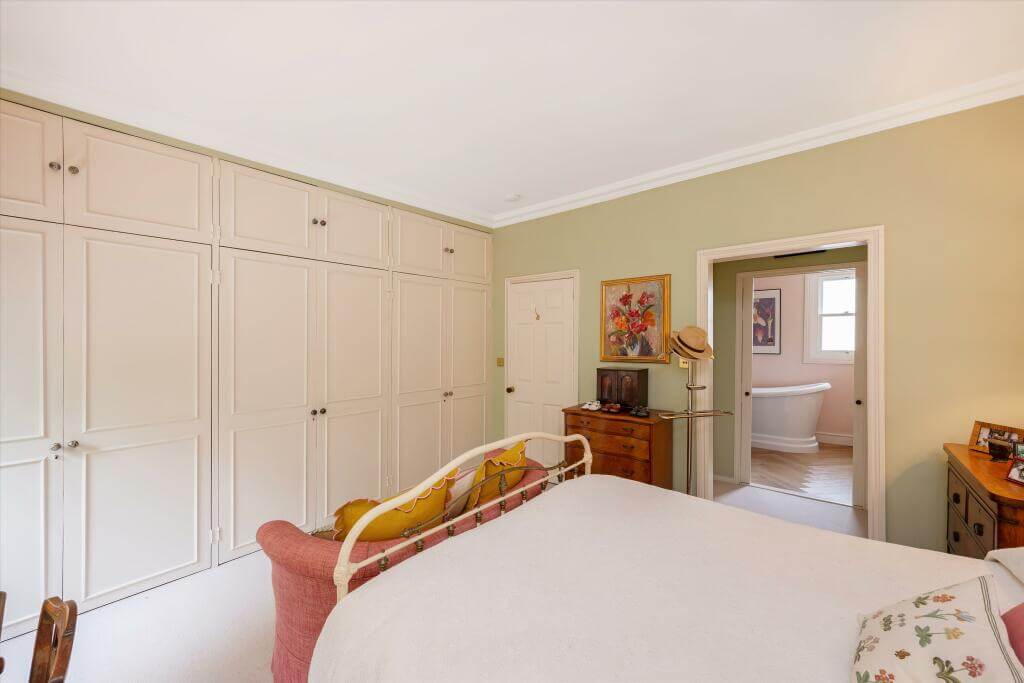 Cottage-style Interiors in a London Family Home 13 serene bedroom with built in wardrobes