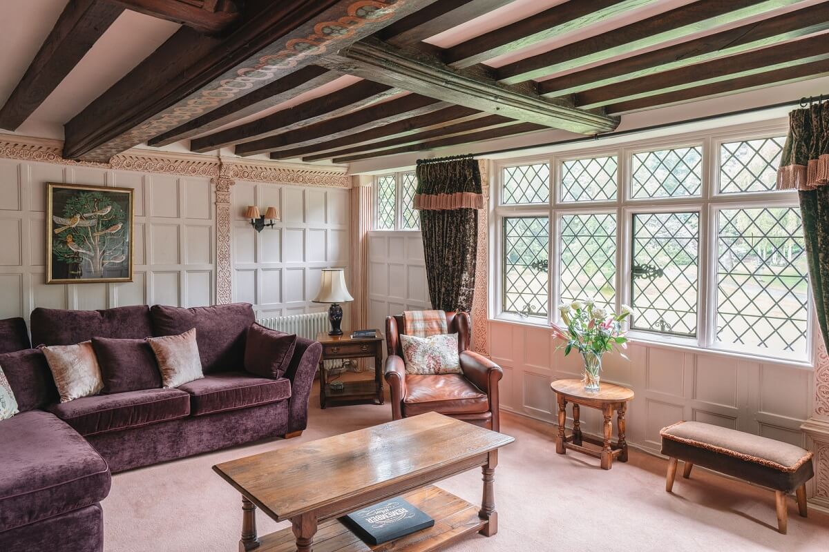 Magnificent Period Features in an English Tudor House 16 sitting room purple sofa Magnificent Period Features in an English Tudor House