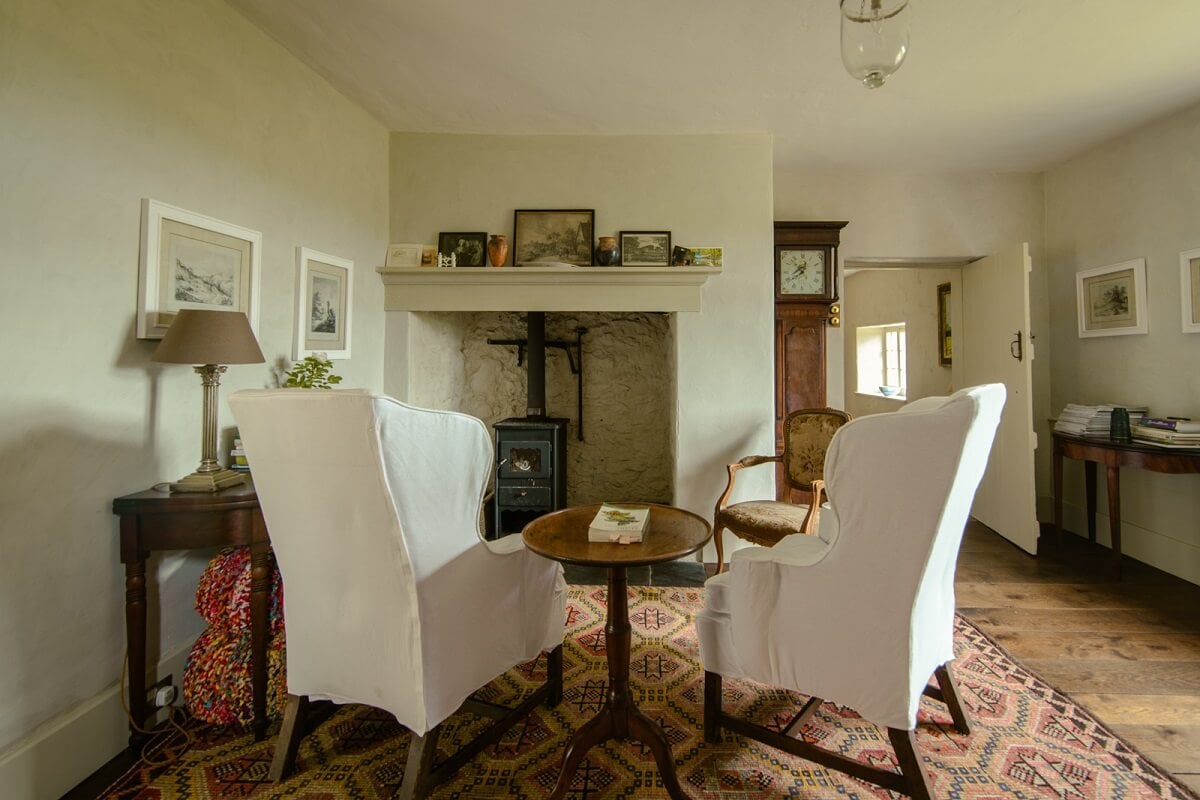 A Yellow Farmhouse with Bold Color Pops in Wales 6 sitting room with antique furniture