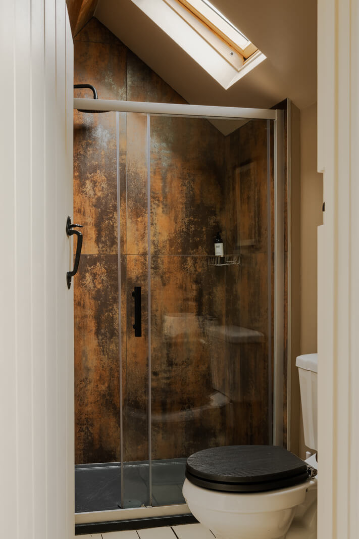 Cottage-Style Interiors in an English Barn Conversion 10 small bathroom pitched ceiling
