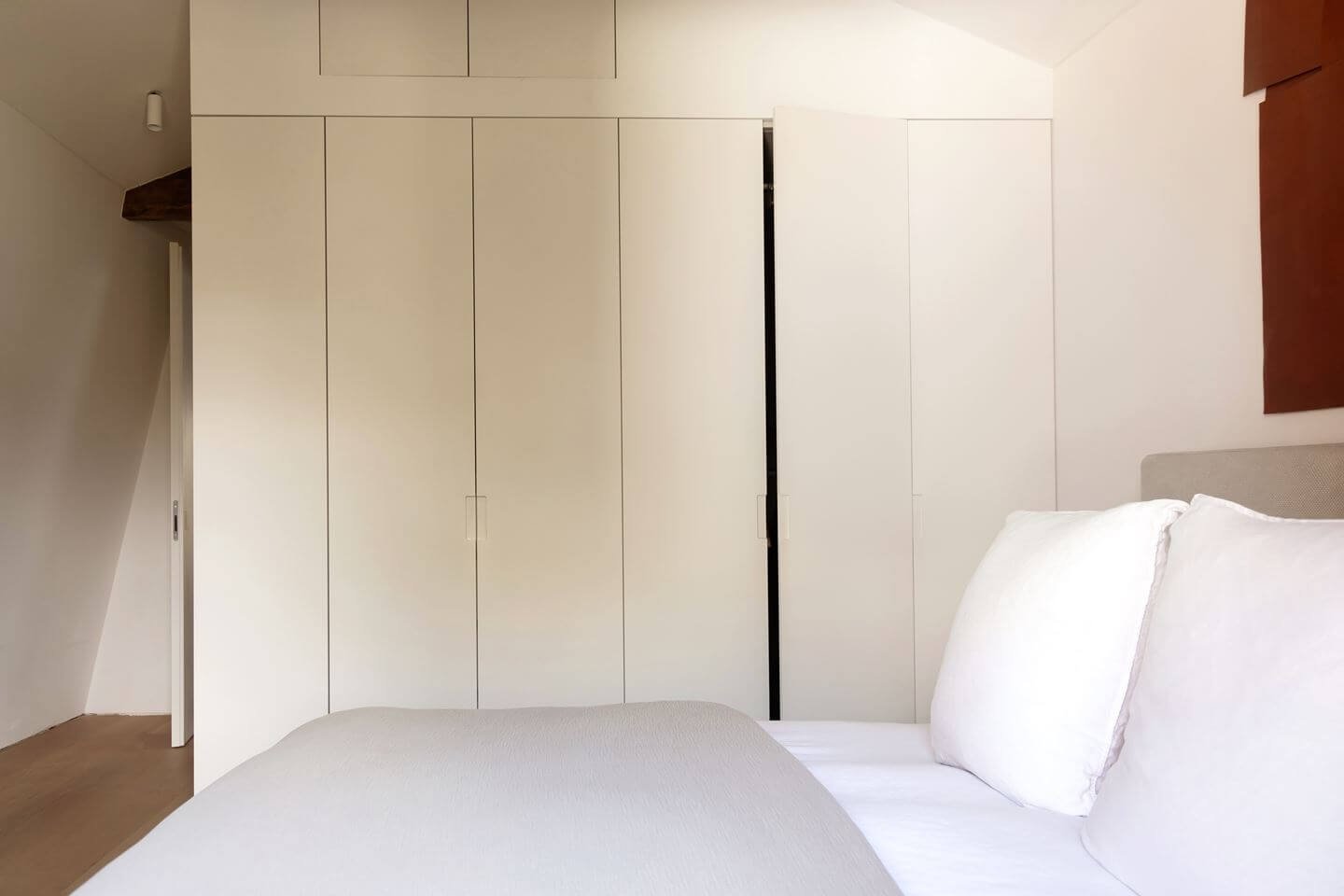 An Apartment with High Pitched Ceilings in an Amsterdam Canal House 15 small bedroom with built in wardrobes