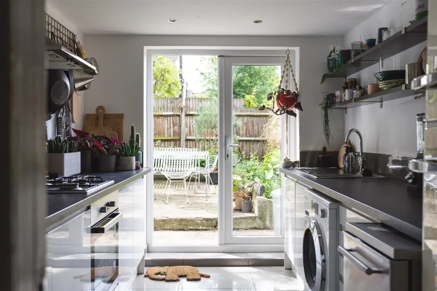 Open-Plan Rooms and Modern Furnishings in a London Home 9 small white galley kitchen with shelves