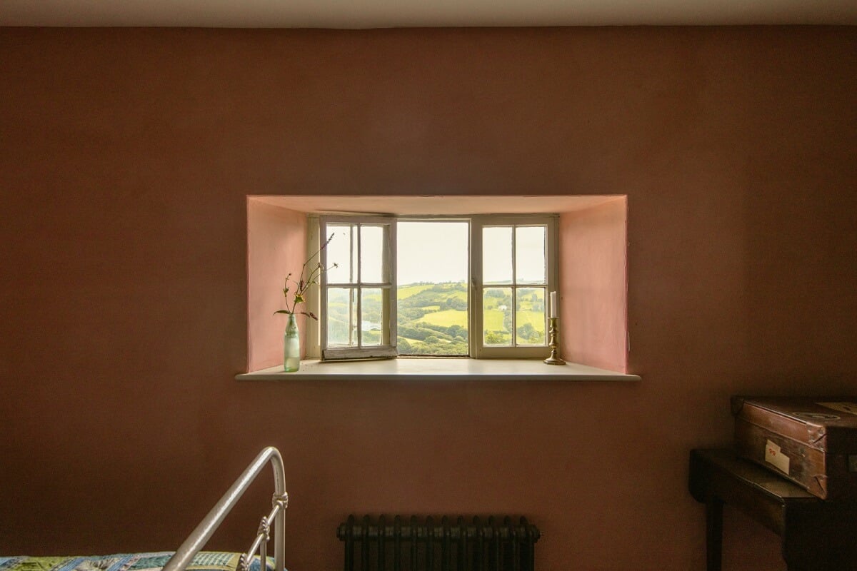 A Yellow Farmhouse with Bold Color Pops in Wales 18 small window pink bedroom