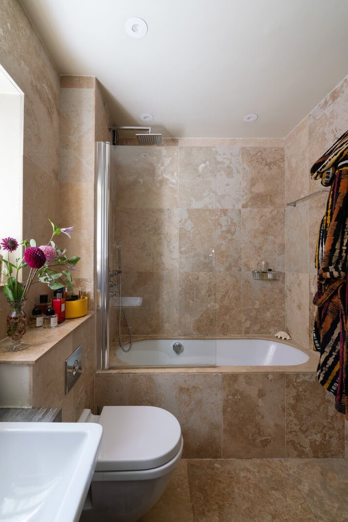 A Moody Color Palette and Eclectic Interiors in a London Apartment 17 soapstone tiles bathroom