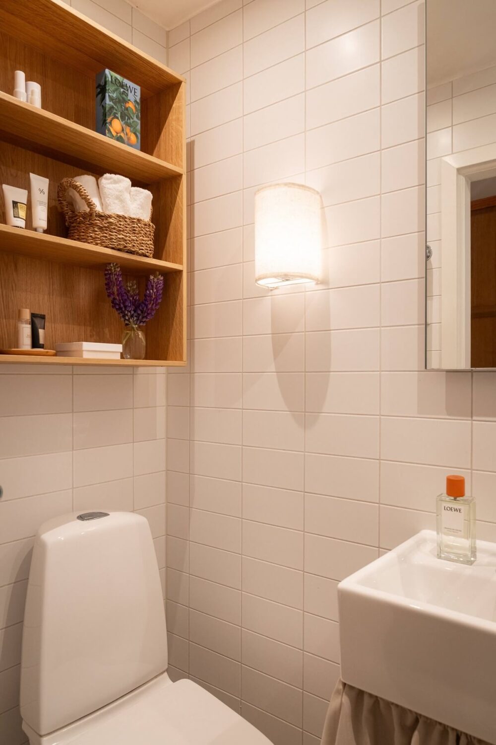 An Elegant Small Renovated Apartment in Stockholm 18 tiny bathroom with oak cabinet