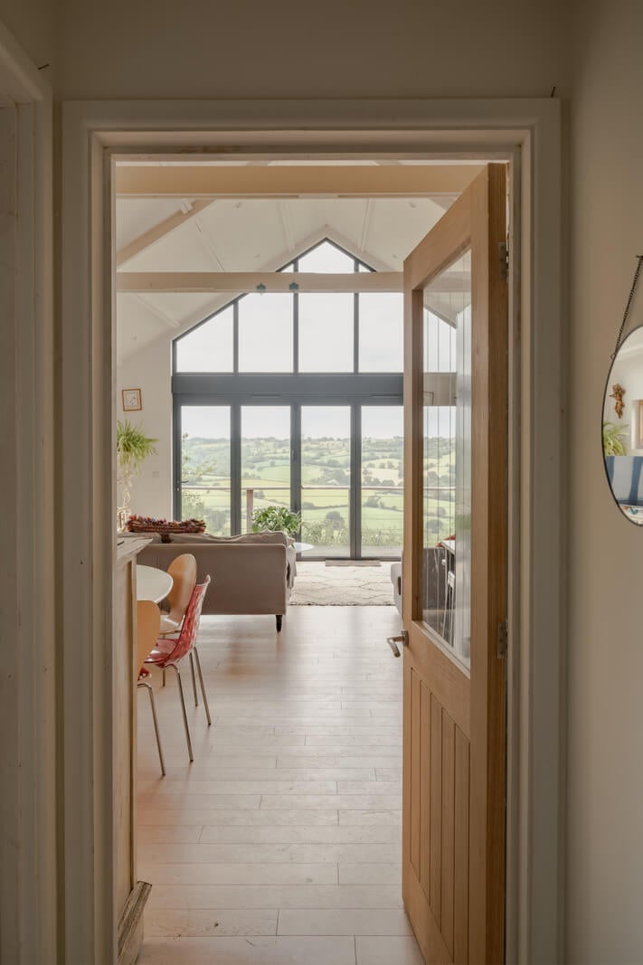 A Black Barn House with Boho Interiors and Breathtaking Views 8 view into living space